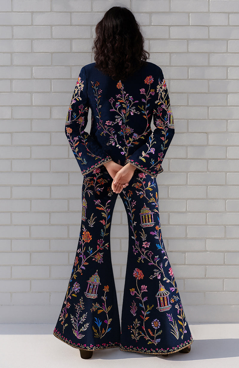Navy flared pant suit with multi-colour Parsi Gara embroidery and long-line open-front jacket.