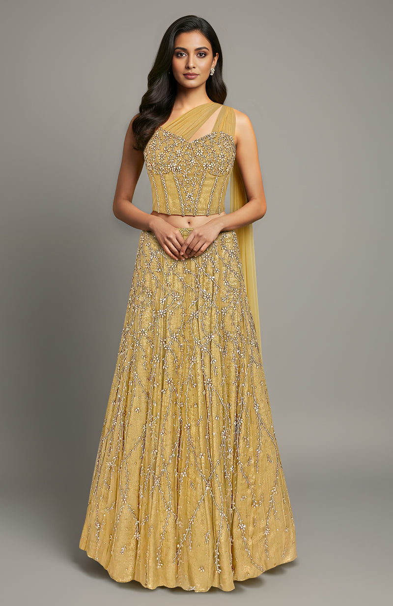 Gold crystal hand-embroidered corset lehenga set with a one-shoulder drape.