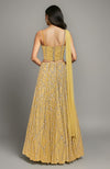 Gold crystal embroidered corset lehenga with a yellow drape.