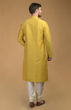 On Her: Mango Mojito Gota Patti & Zari Anarkali Set | On Him: Sunglow Yellow Pintuck Kurta & Mustard Waistcoat Jacket Set
