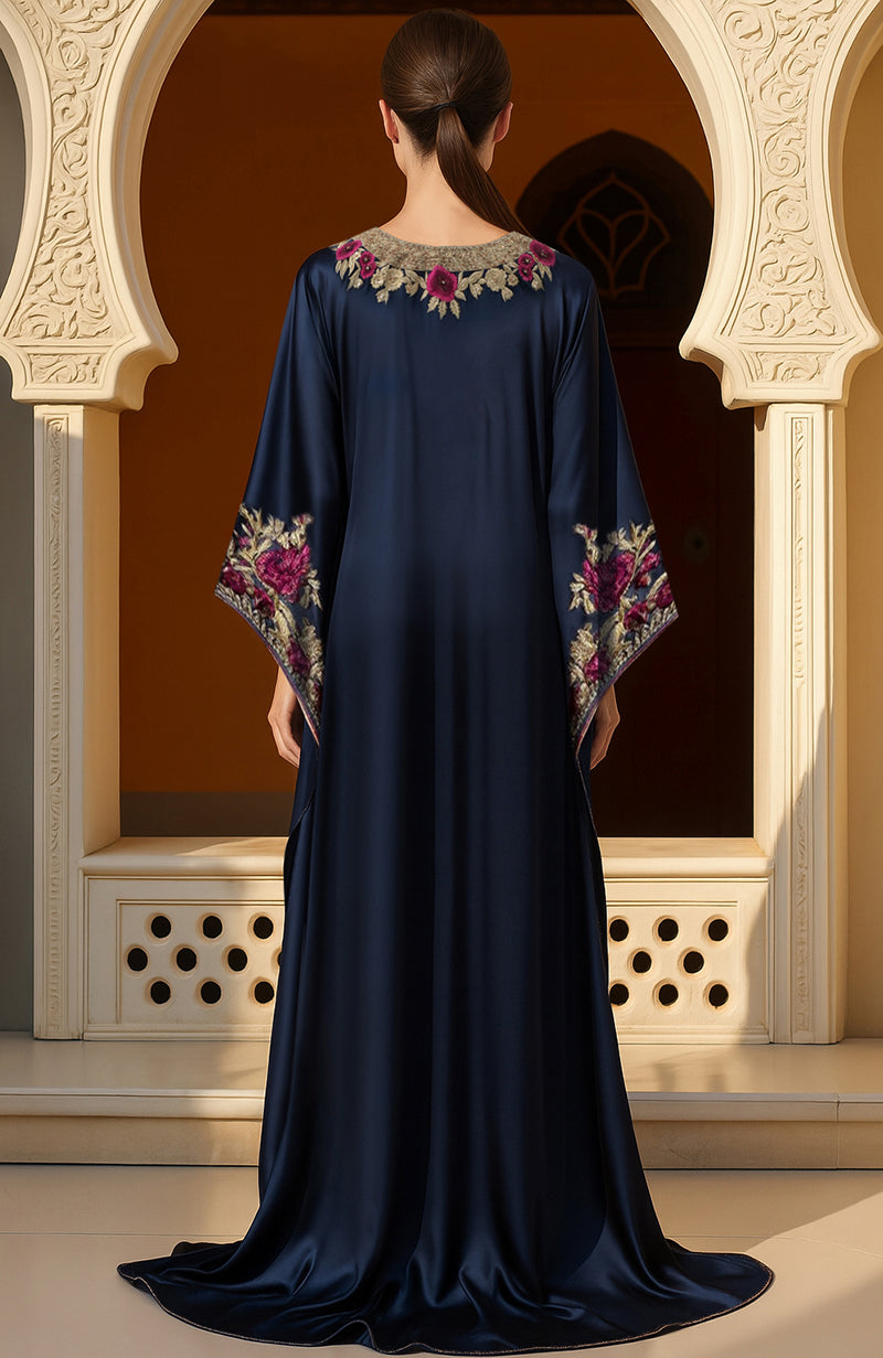 Navy blue kaftan dress with gold and burgundy floral embroidery and wide flowing sleeves.