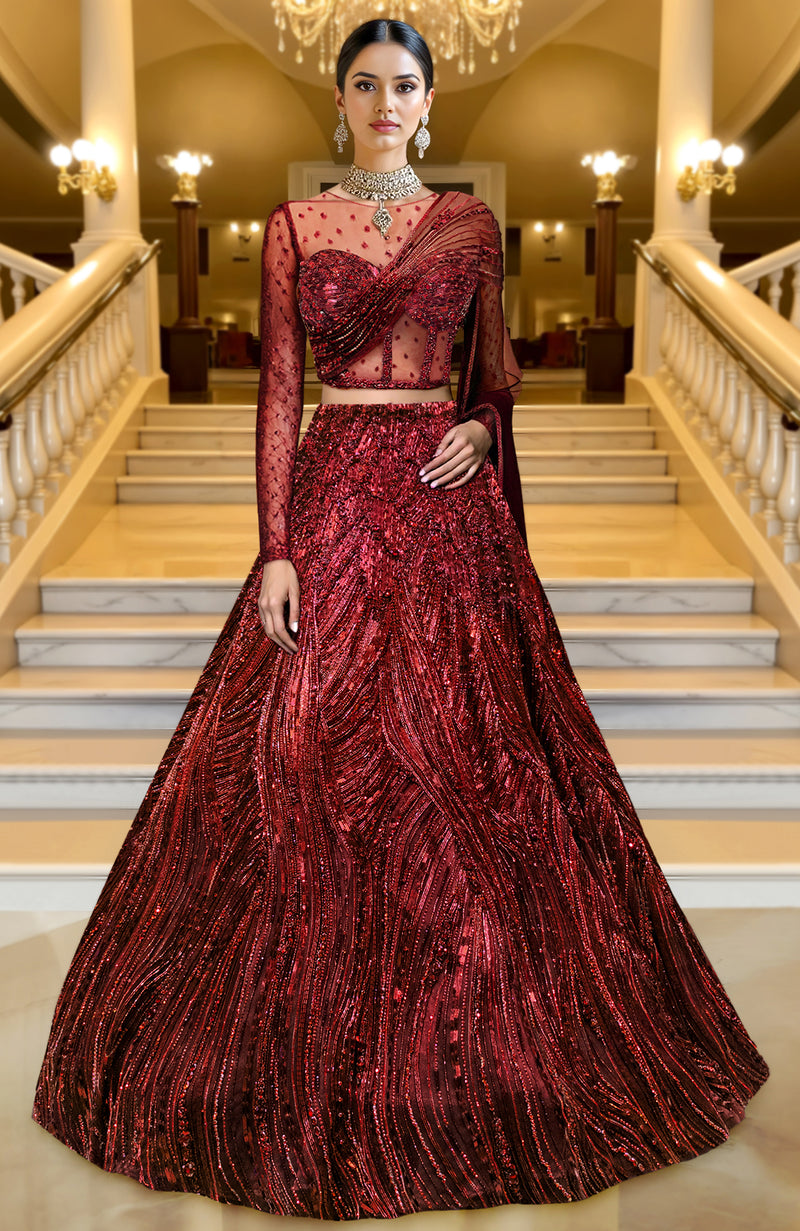 Deep maroon lehenga set with intricate embroidery and a sheer cape draping elegantly.