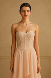 Strapless blush gown with pearl and bead embroidered corset and flowing tiered skirt