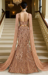 Rose gold hand-embroidered mermaid lehenga set with a sheer draped cape and structured corset blouse.