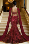 Deep wine maroon mermaid lehenga with heavy sequin embroidery and sheer net cape.