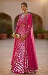 Golden lehenga set with hand-embroidered mirrors and sequins, paired with a pearl-embellished sheer cape