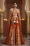 Amber lehenga with mirror embroidery, sleeveless square-neck blouse, and full-length mirror cape.