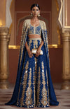 Amber lehenga with mirror embroidery, sequins, and a full-length mirror cape from Jalwa collection.