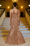 Rose gold strapless mermaid gown with hand-embroidered sequins and beadwork in swirling patterns.
