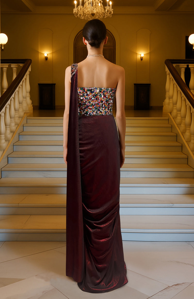 Structured multicolored crystal-embellished corset with one-shoulder strap and deep maroon saree drape