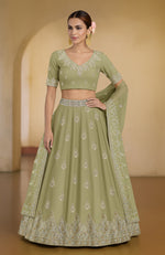 Bog green Kashmiri lehenga set with tilla and zardozi embroidery on blouse, skirt, and dupatta.