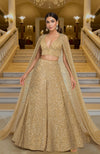Gold lehenga set with hand-embroidered beads and sequins, deep V-neck blouse, and cape dupatta.