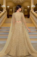 Gold lehenga set with hand-embroidered beads and sequins, deep V-neck blouse, and cape dupatta.