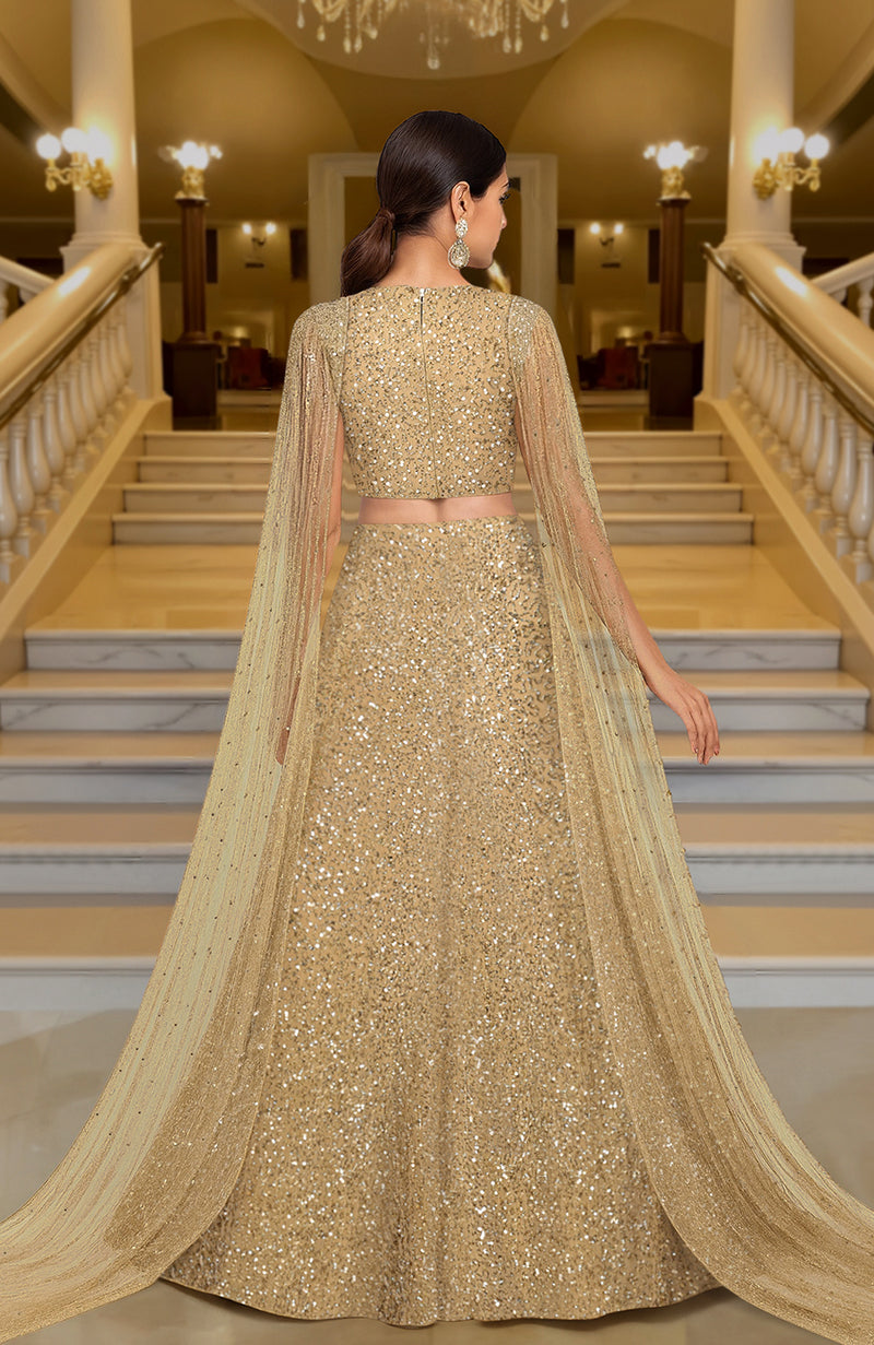 Gold lehenga set with hand-embroidered beads and sequins, deep V-neck blouse, and cape dupatta.