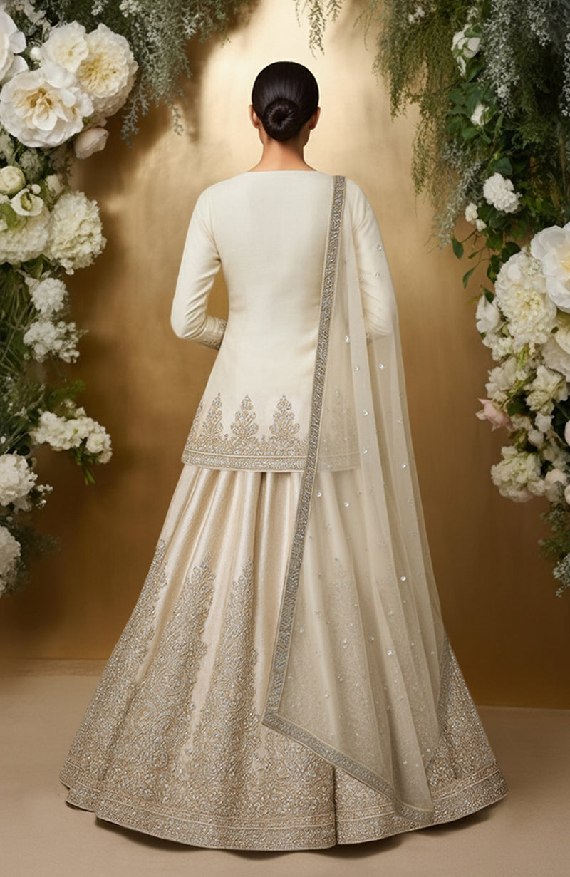Ivory lehenga set with embroidered motifs, sequins, and a soft tulle dupatta.