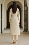 Ivory long-line kurta with embroidered paisleys and matching straight trousers.