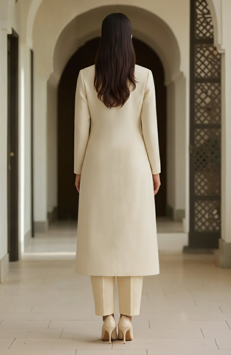 Ivory long-line kurta with embroidered paisleys and matching straight trousers.