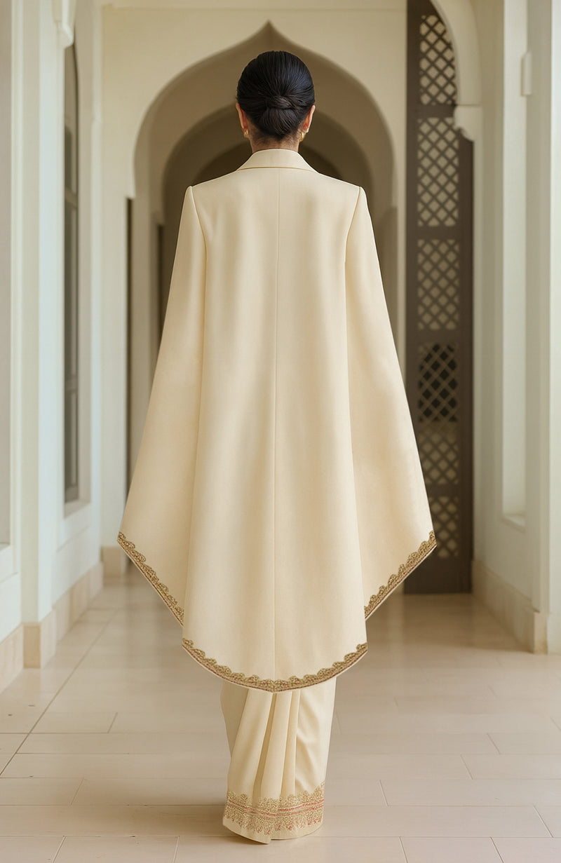 Ivory pre-draped chiffon saree with an embroidered paisley cape and flowing silhouette.