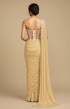 Back view of champagne gold saree with crystal-studded corset blouse and draped pallu.