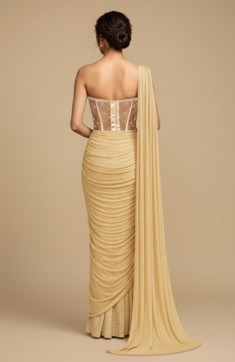 Champagne gold draped saree with a crystal-studded corset blouse and fluid pallu.