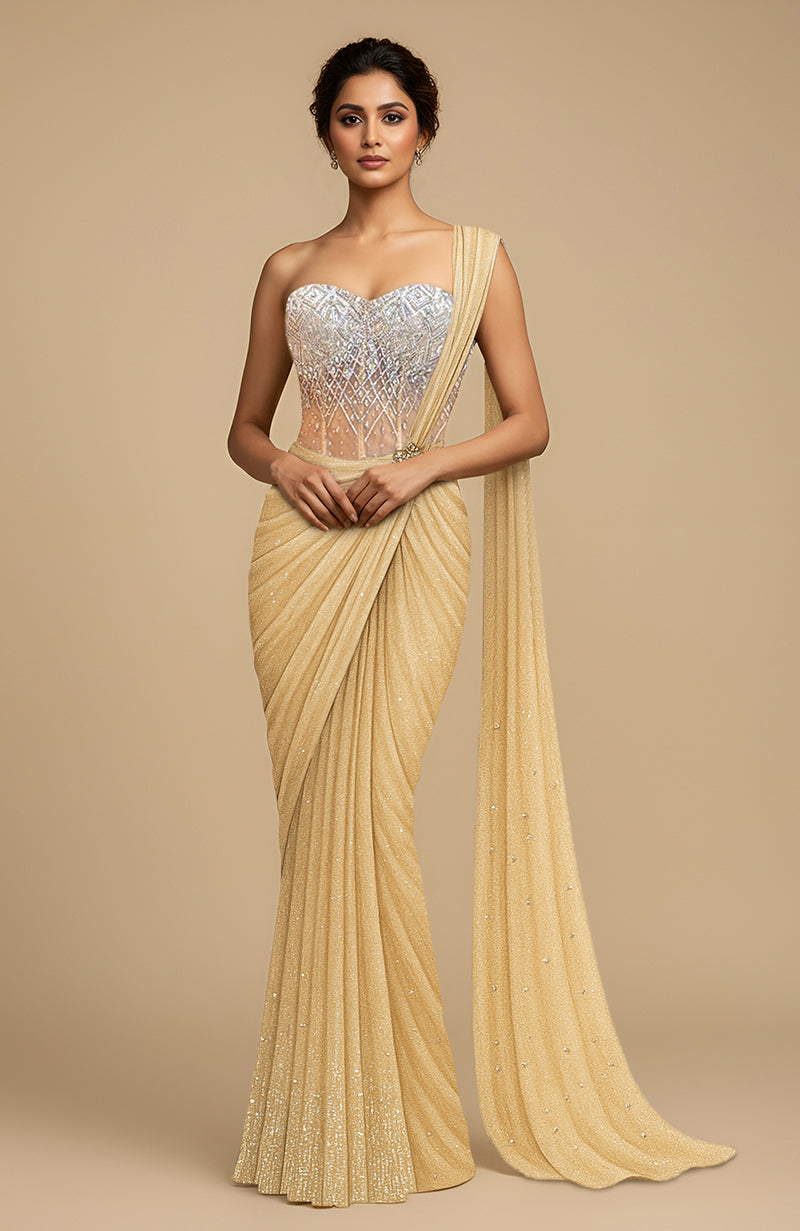 Champagne gold draped saree with a crystal-studded corset blouse and fluid pallu.