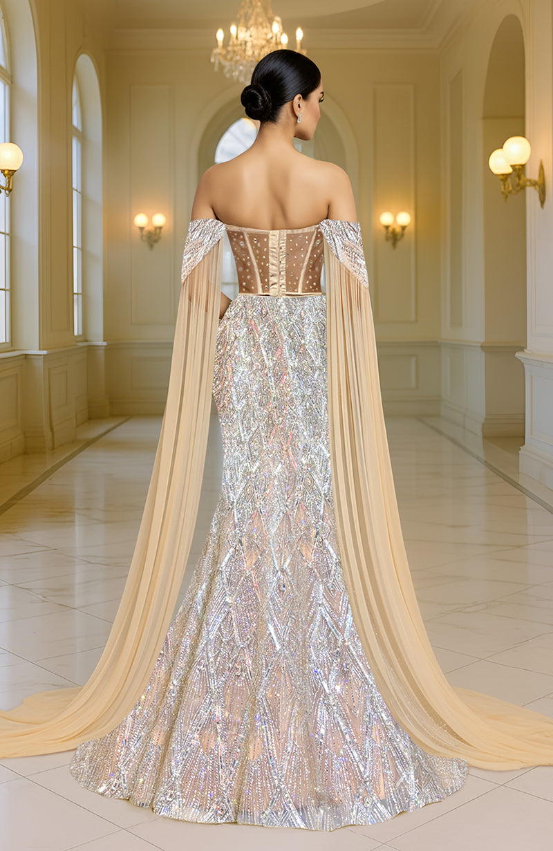 Silver champagne mermaid lehenga with intricate embroidery and a matching flowing cape.