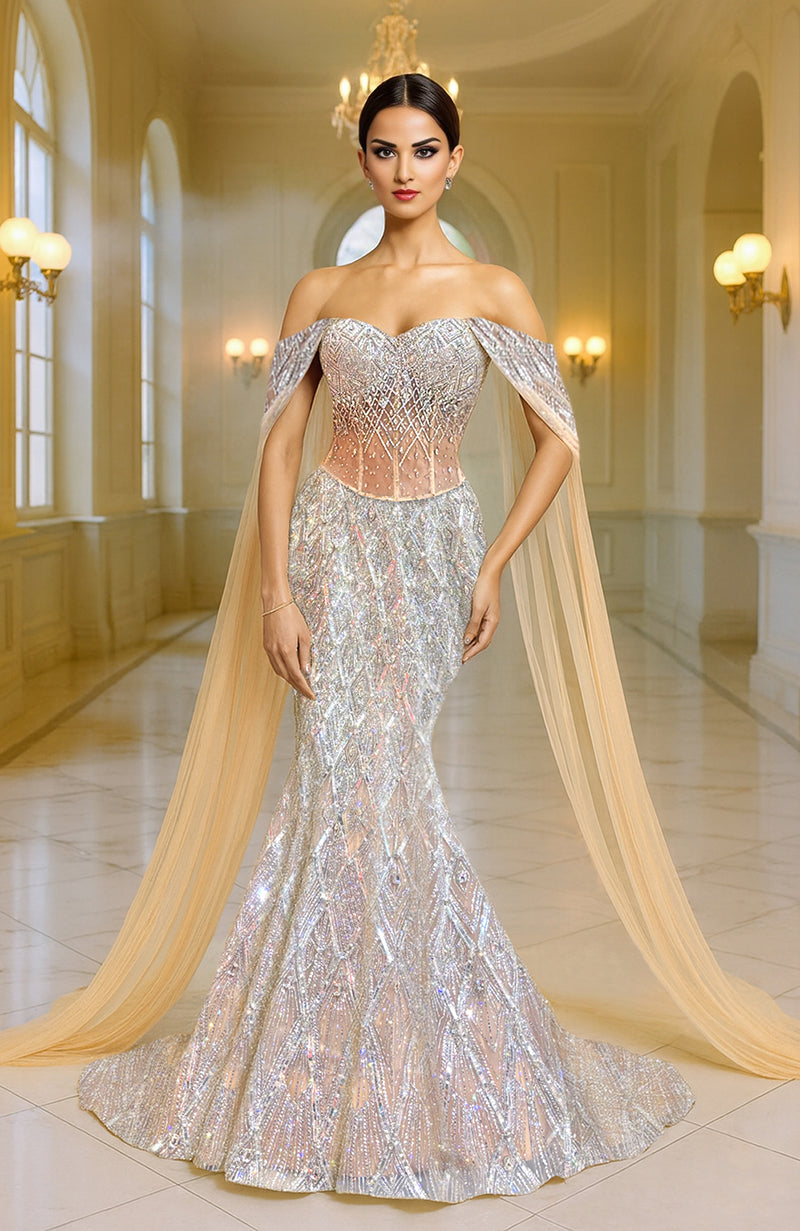 Silver champagne mermaid lehenga with intricate embroidery and a matching flowing cape.