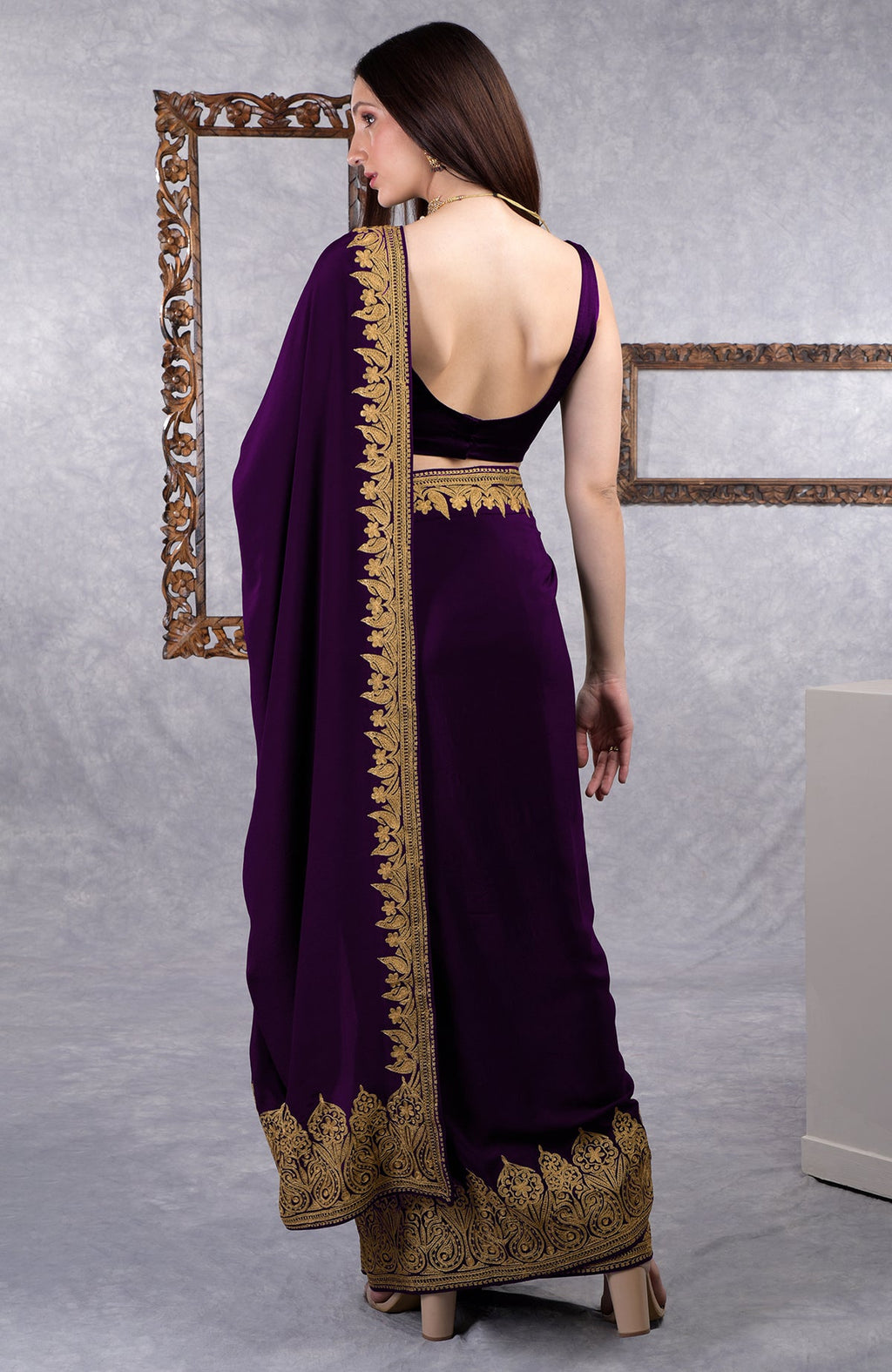 Dark plum crepe saree with gold Kashmiri tilla aari floral and paisley embroidery border.